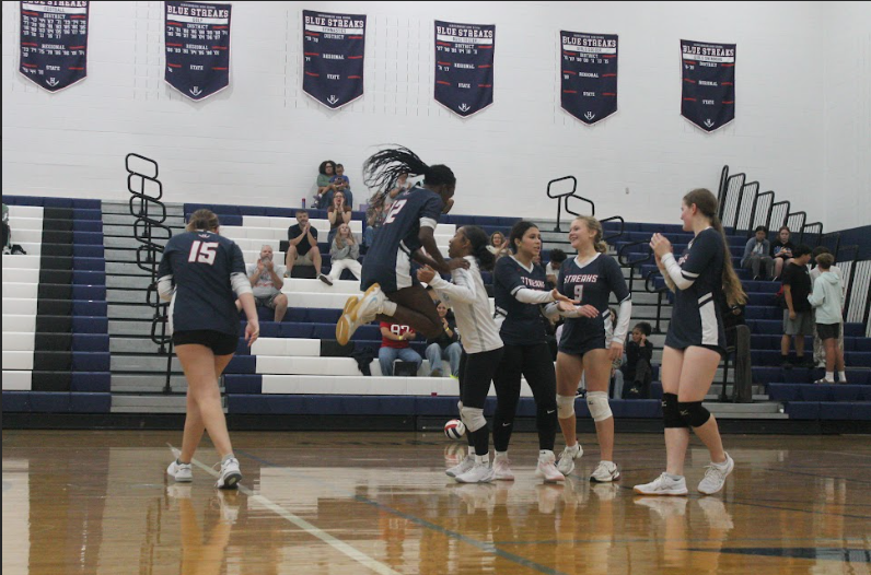 Sophomore Ziyra Wilcoxen jumps up and down after the team wins a point.