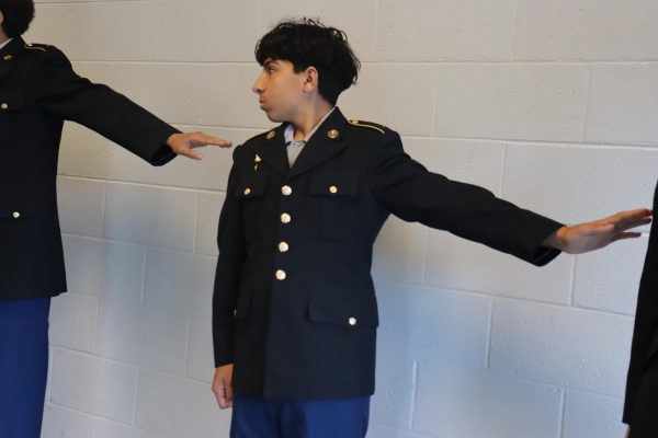 Freshman Malik Balak following the command of dress right dress.