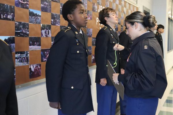 Freshman Daniel Nyokie getting inspected on his JROTC uniform.