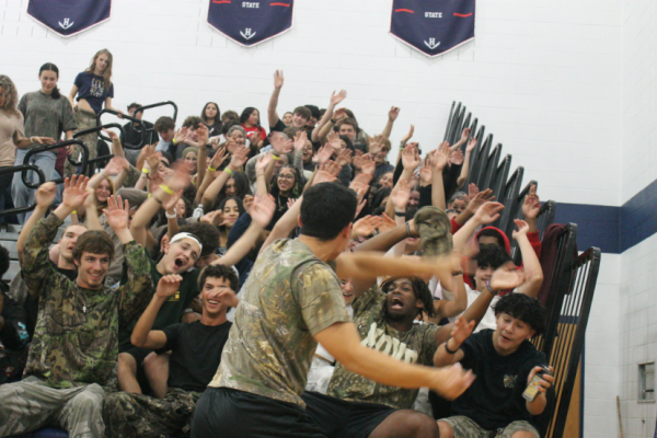 Senior Gabe Sabari leads the student section on a roller coaster ride.