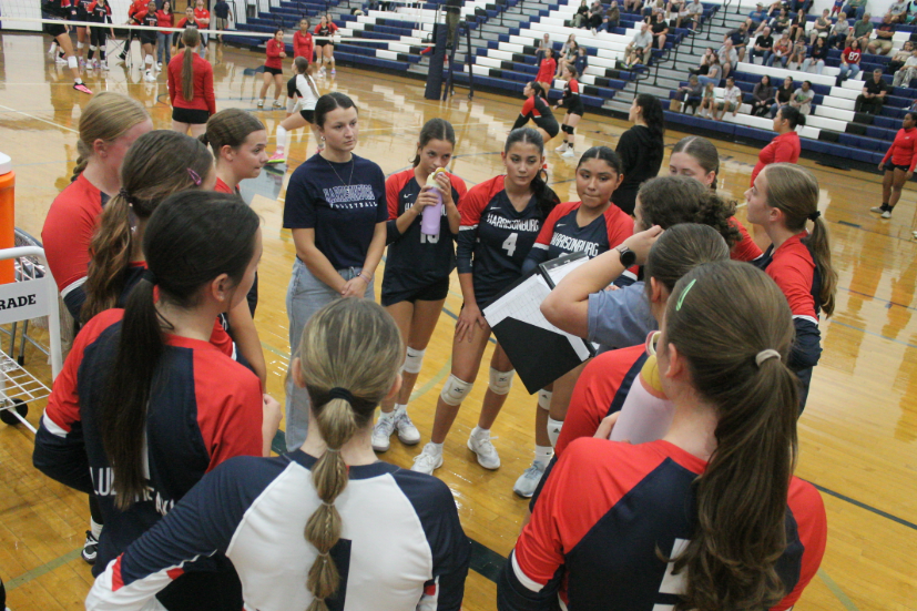 The HHS volleyball players and coaches talk through the game plan before the game.