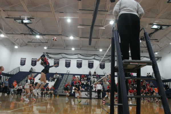 Sophomore Maren Bert spikes the ball over the net.