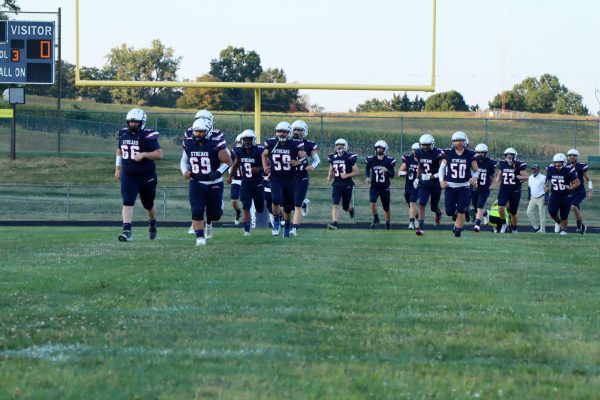 Football players run