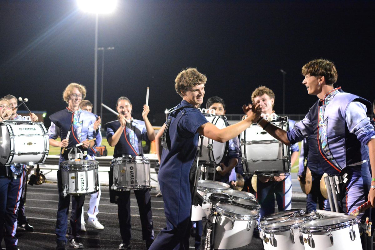 Seniors Billy Perritt and Eli Long dap each other up after performing Jig 2.
