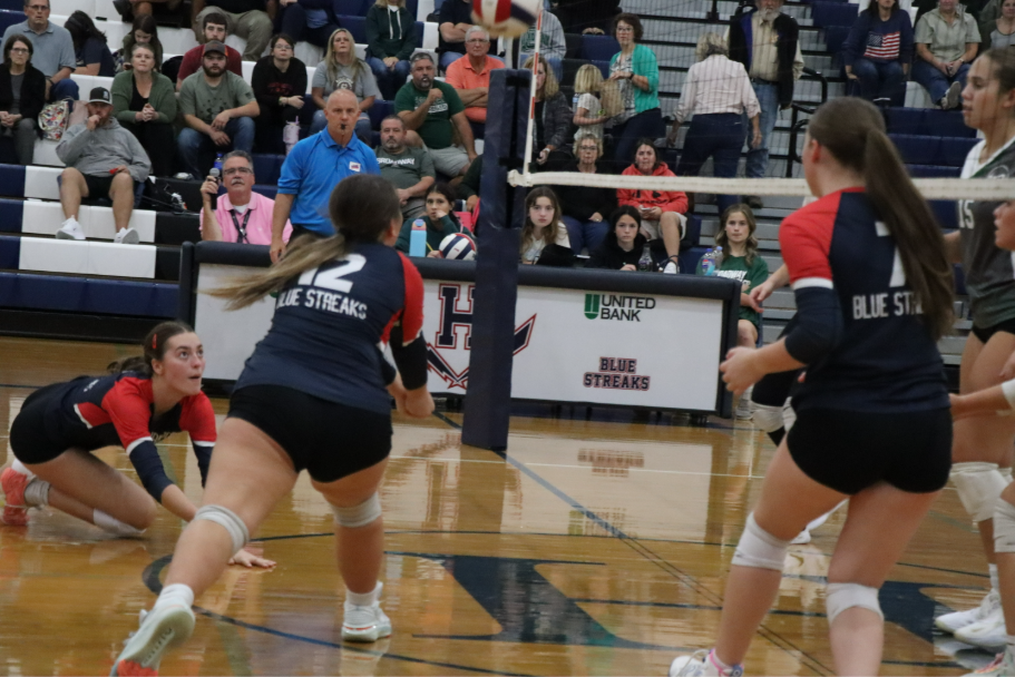 Junior Nora Von Rotz and junior Jordyn Byler dive on the floor to keep the play alive.