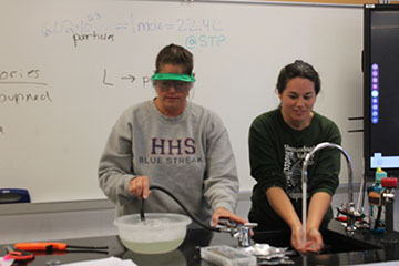 This is Ms. Smith and her helper preparing the ingredients she is going to need for the trick she is going to show in class.