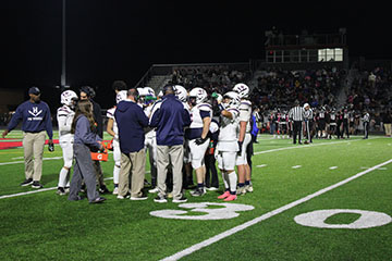 The coaches calling out time out so they can talk to the players and about there game plan.
