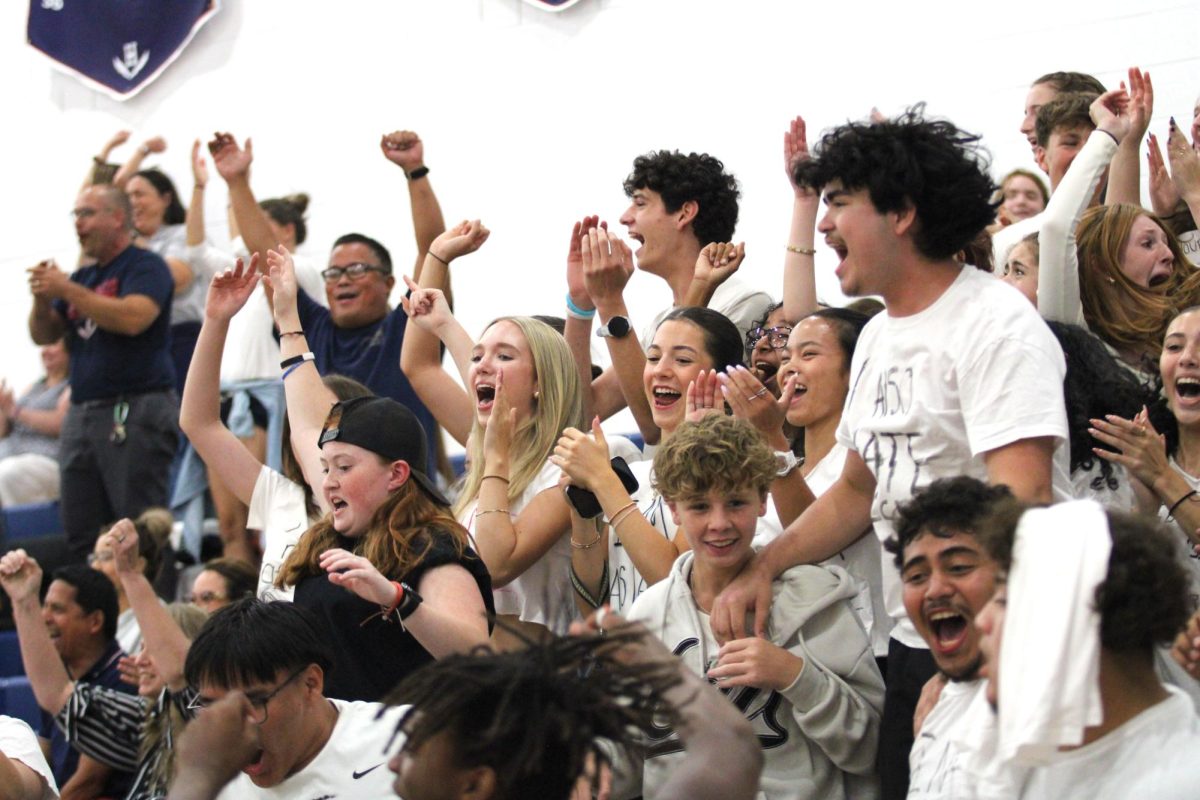 Student section gets loud for the Girls varsity volleyball team.