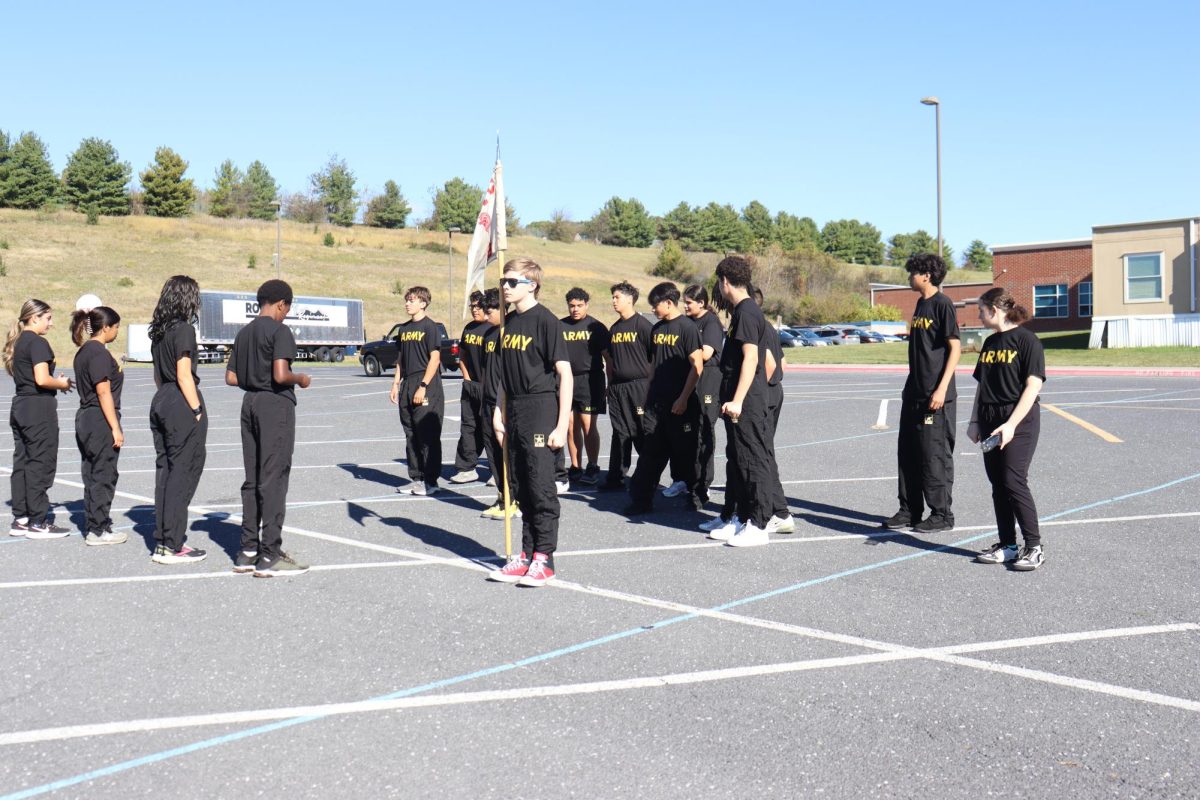 JROTC stands in formation on black top.