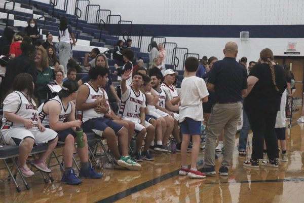 The team sitting on the sideline Gloria Ottaviano, coach of the HHS Unified Basketball team, commented "Coaching students with different abilities has taught me that anyone can play. No matter the disability or skill, it can be fun for everyone"