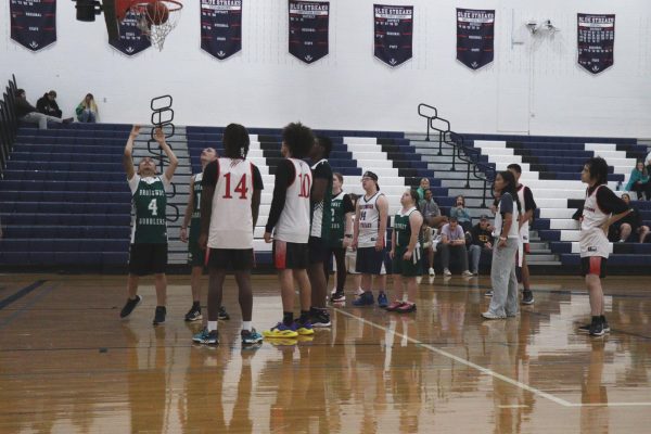 The basketball team watching the opposite team score a point