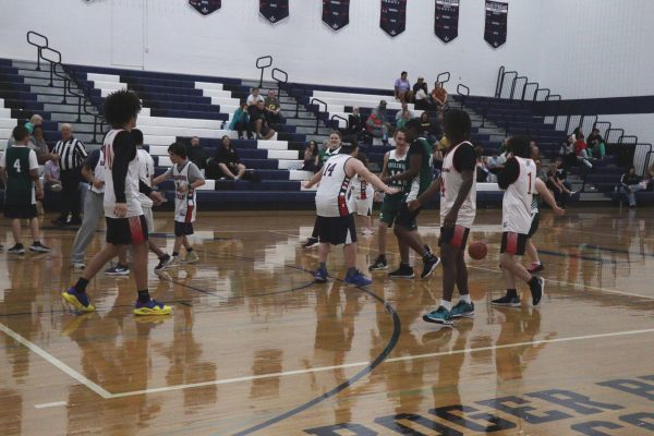 Number 14 blocks a team member from the opposite team