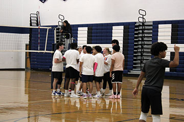 The Seniors huddling up to get ready for their match with the Freshmans.