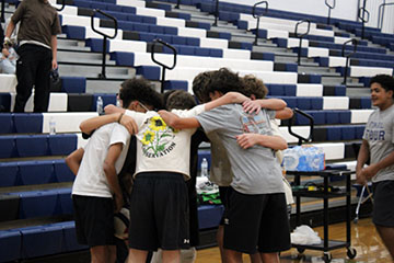 The Freshmans huddling up to talk about their game plan against the Seniors.