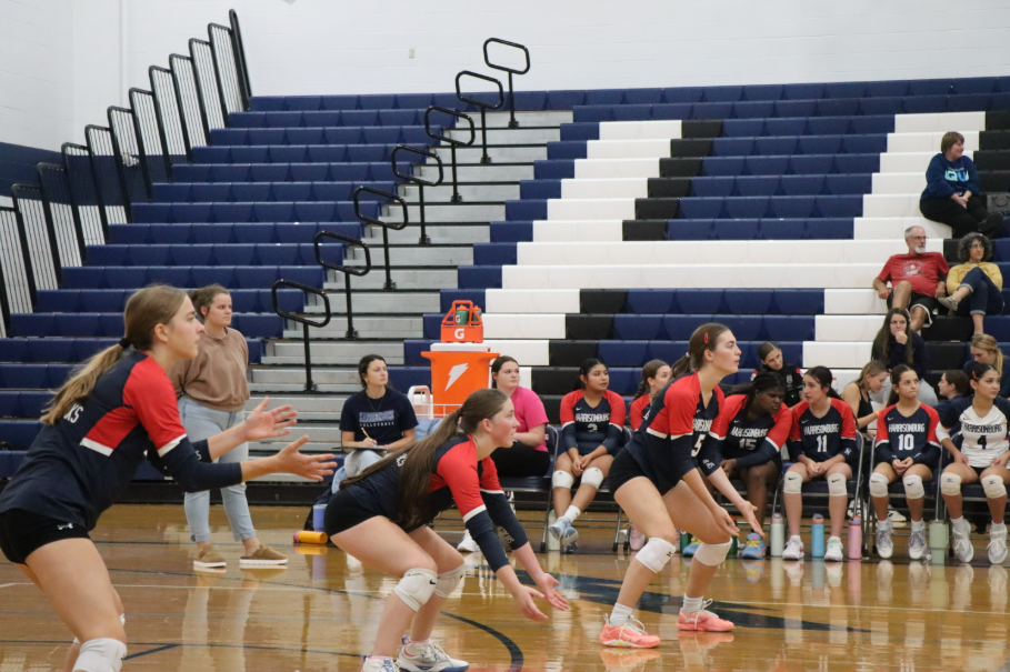 Sophomore Maren Bert, sophomore Delaney Dayton, and junior Nora Von Rotz prepare for the next incoming serve.