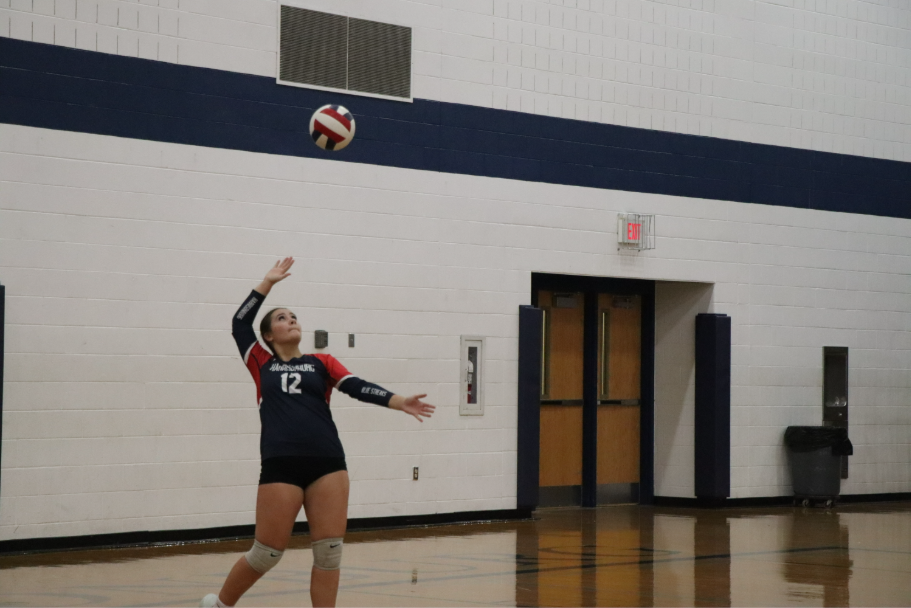 Junior Jordyn Byler serves the ball.