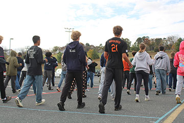 The students warming up before they start practicing since its cold.