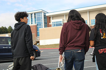 The trumpet section talking about what they did wrong last comp.