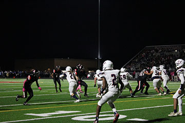 The players tackling the Rock town players so they don't get more points in.