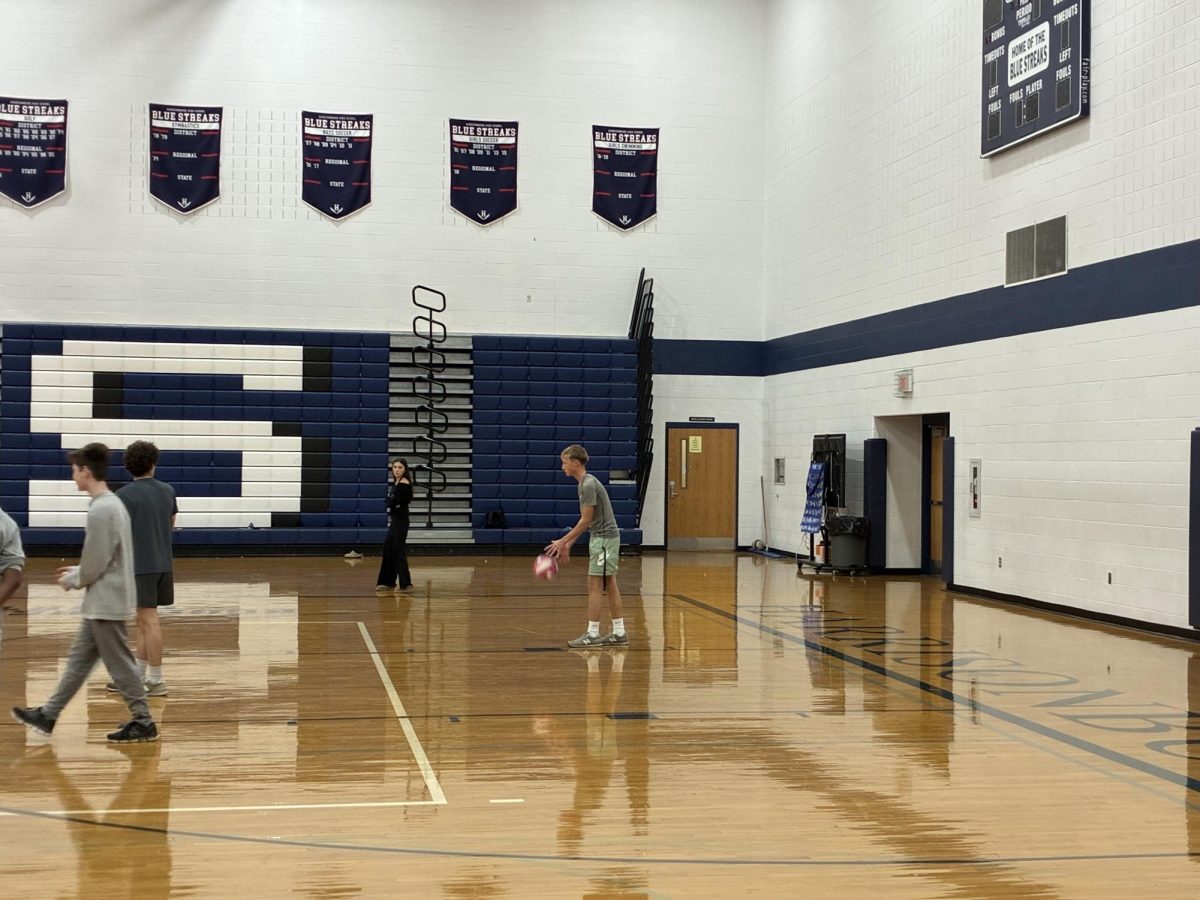 Sophomore Josiah Gingerich gets ready to serve the ball to the junior team.