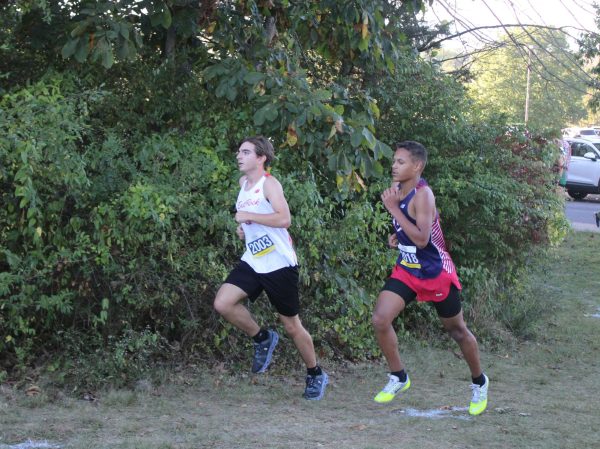 Sophomore Julius Michael keeps up with opponent.