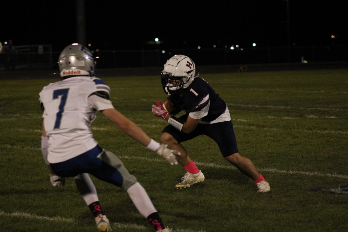 Senior player Fernando Rodriguez makes a catch and faces off against a defender from Spotswood.