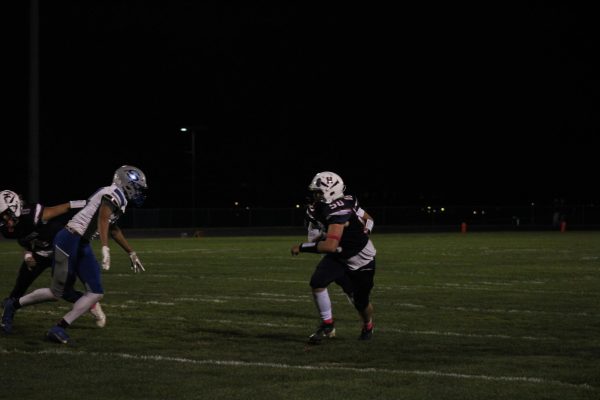 Sophomore Reuben Miller runs at a Spostwood Blazer Player.