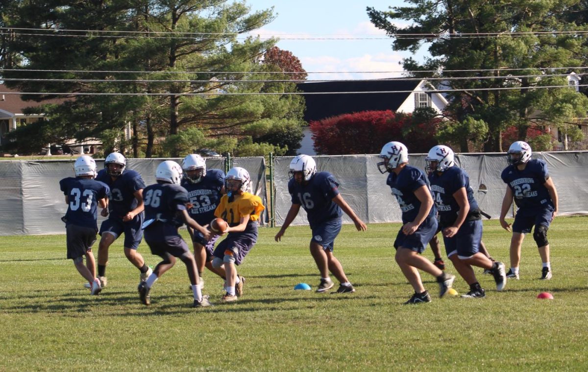 JV football practicing plays for a game.