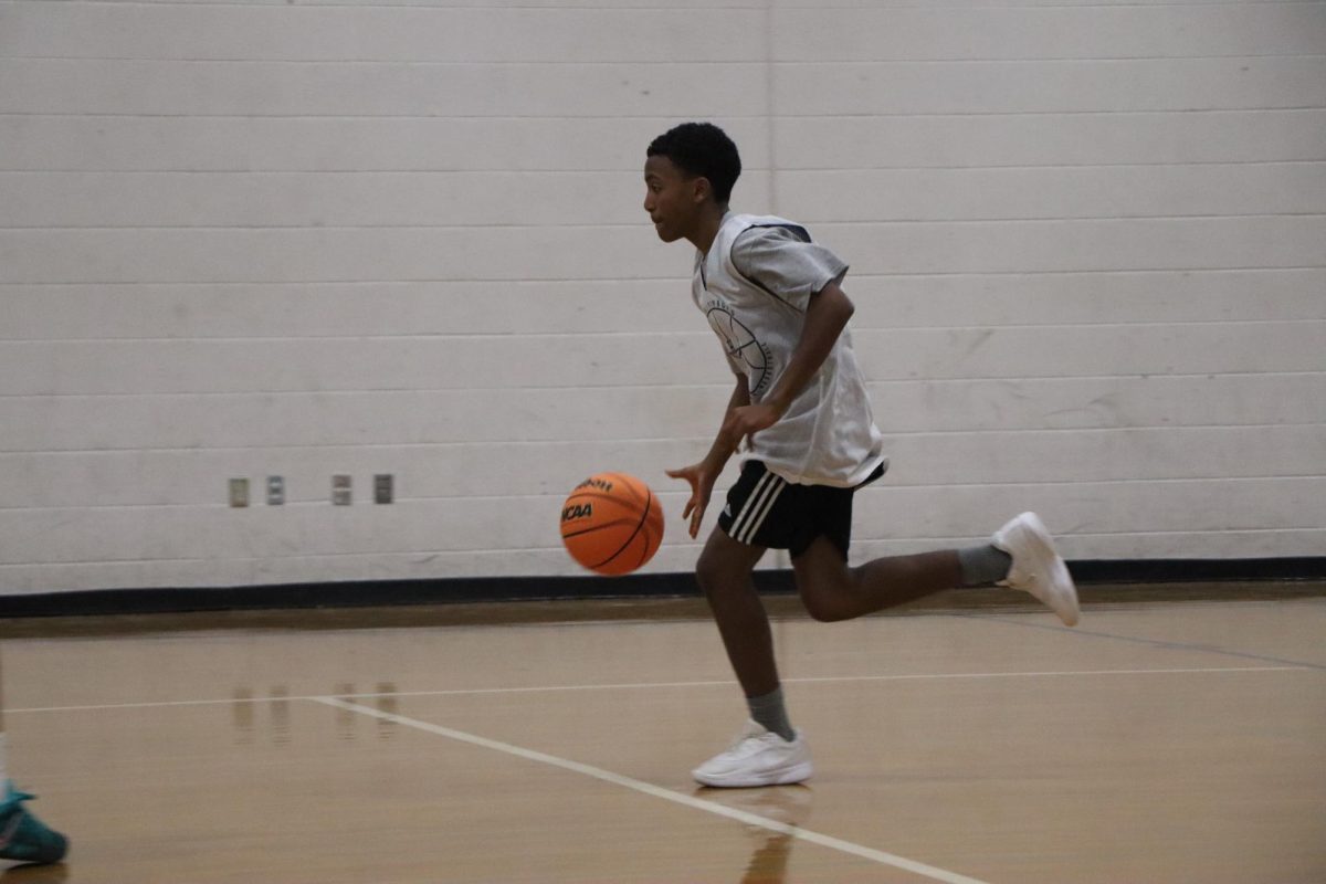 Freshman Dagmawi Abrha dripples the to the other side.