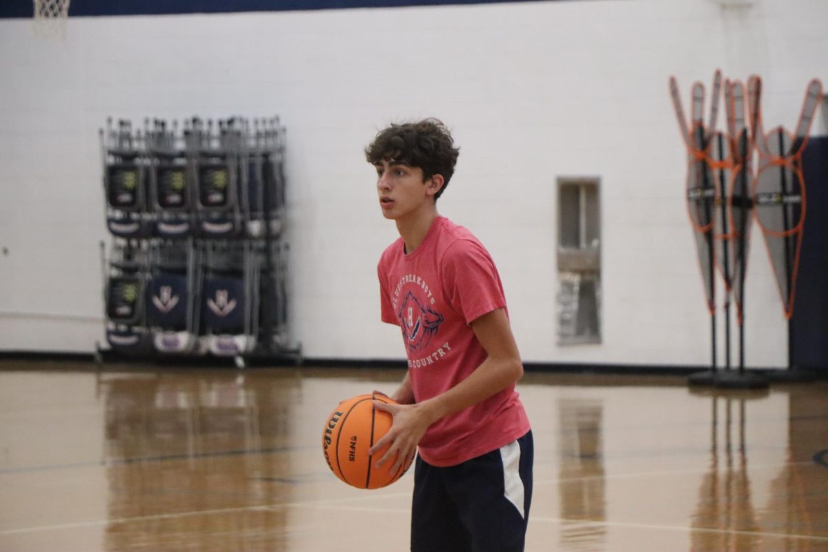 Freshman Kyle Rush prepares to pass the ball to one of his teammates at practice. 