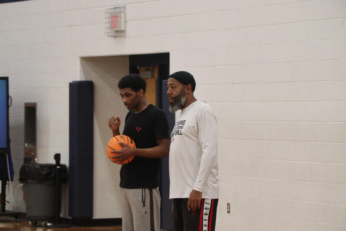 Junior Qwanell Franklin-Fry Listening to his coach about the game play at practice.