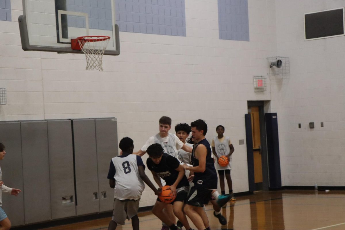 JV boys basketball go for the ball at practice.