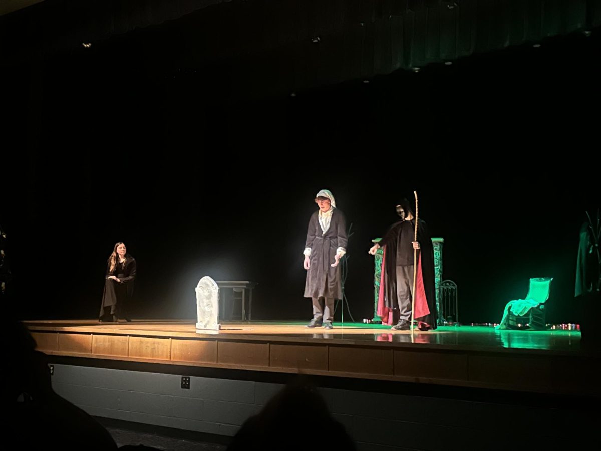 An actor stands alone under the lights, delivering a powerful moment in the scene. "This part is really interesting on how he finally isn't a curse anymore"-Freshmen Talia Robles