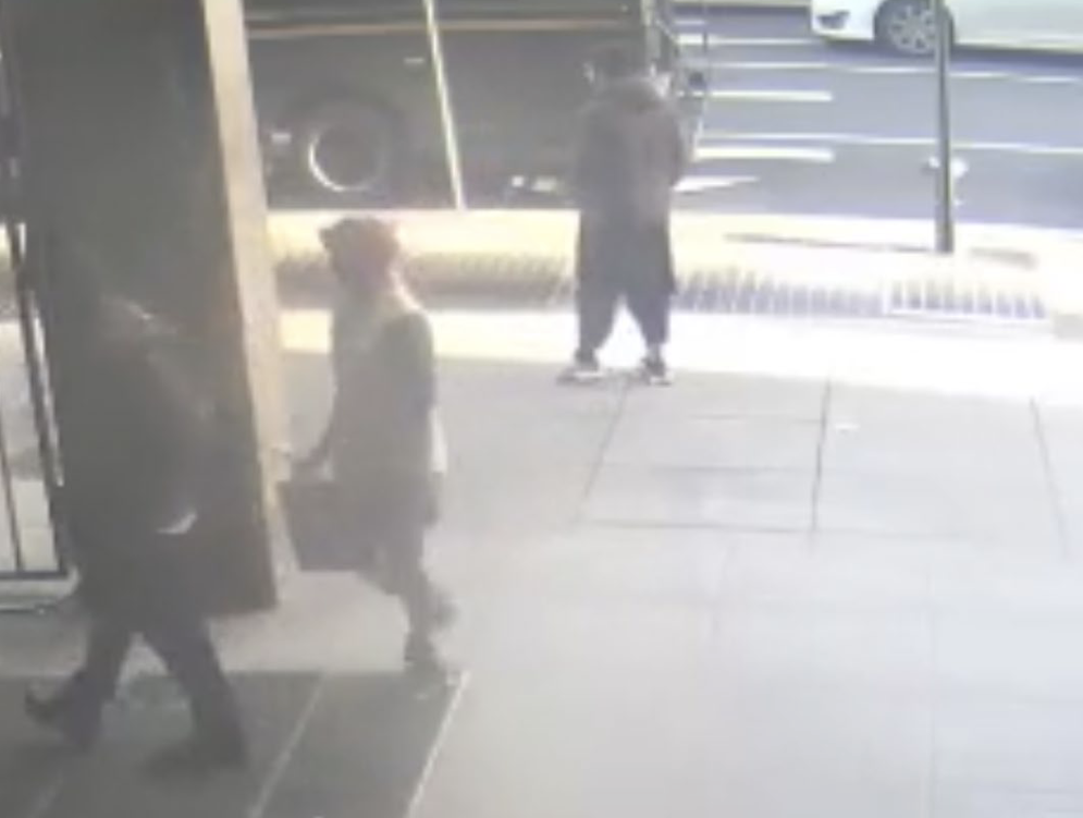 Alleged shooter, Lakanwal, stands on the sidewalk of I St NW outside the Farragut West Metro Station before running towards the intersection according to court documents from the Superior Court for the District of Columbia Criminal Division. (Superior Court for the District of Columbia Criminal Division). 