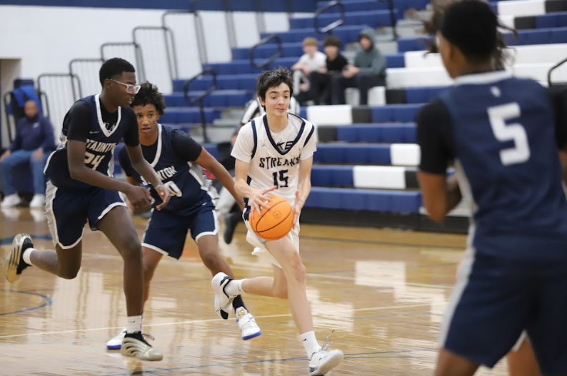 Sophomore John Lichti keeps the ball away from the defenders.