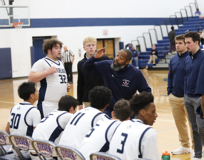 The team gathers around head coach, Matt Williams during a timeout.