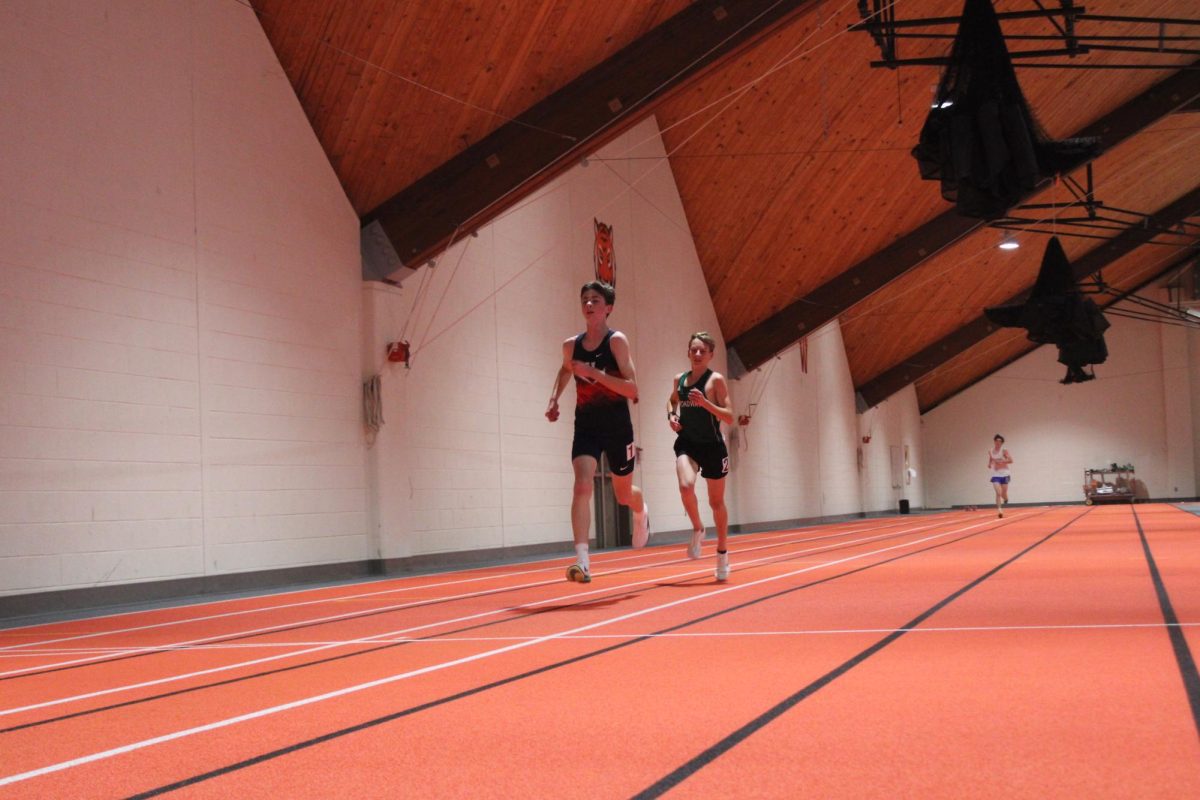 Sophomore Joah Newcomer-Miller leads the 3200 meter run, making an attempt to make some distance between him and second place early.