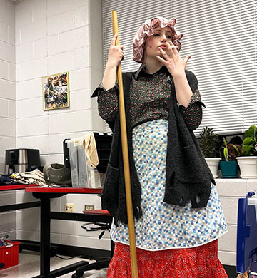 Senior cast member Wren Hamner in the outfit for their character, the scrubwoman.