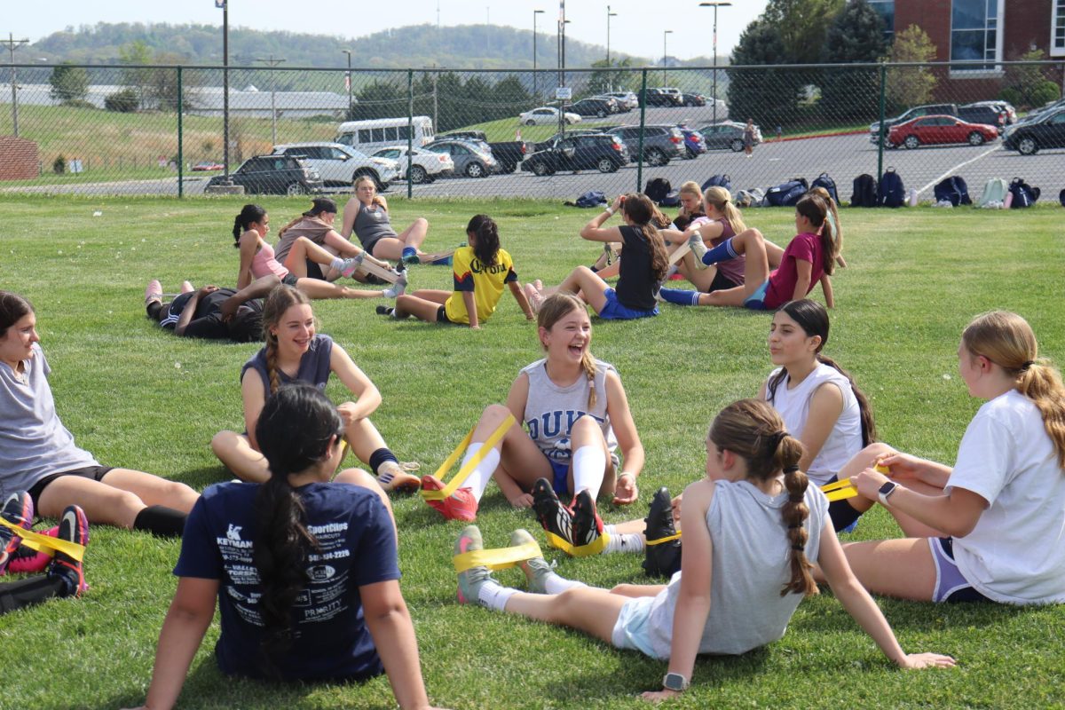 The girls JV soccer team stretches together during practice to warm up and prevent injuries before drills. "Stretching helps us get ready so we don't get hurt and can play our best" Sophomore Escarlen Ayala said.