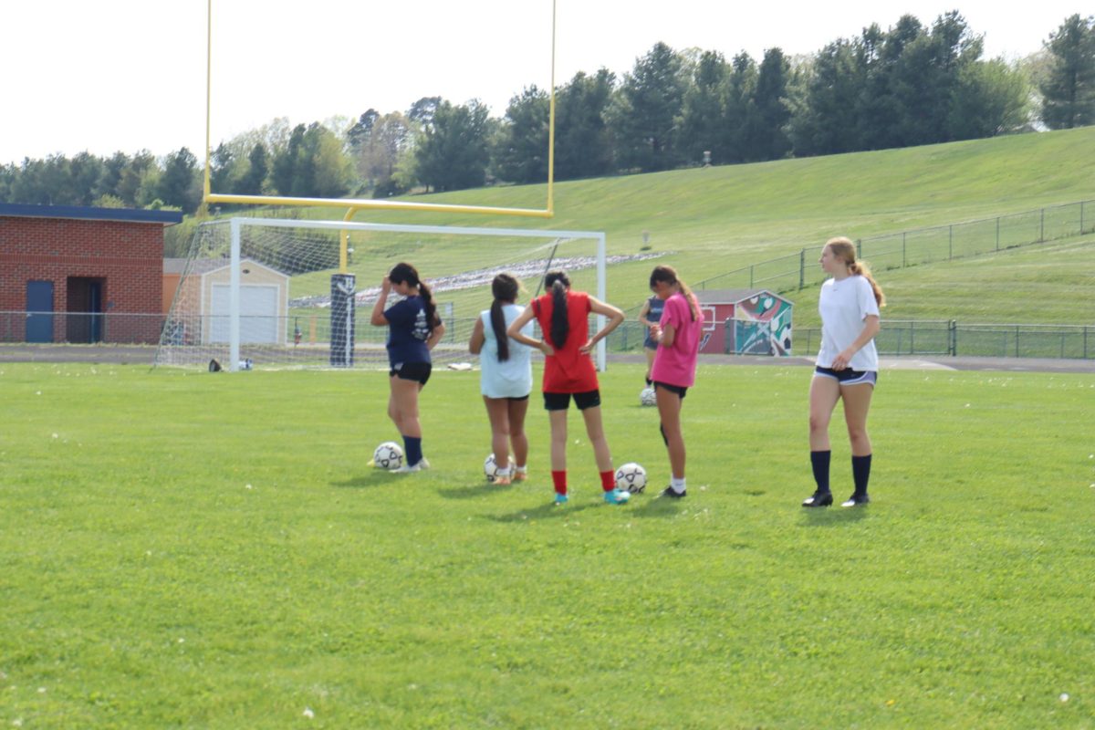 JV Girls Soccer listens closely as they prepare for the next drill during practice.   ¨ We try to stay focused so we know exactly what to do next.¨ Freshmen Liliana Cruz said. 