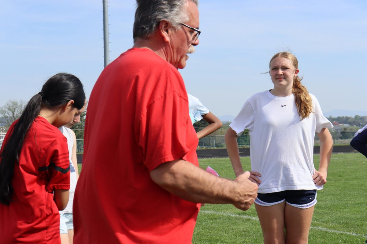 Jeff Mumaw the coach for the JV girls soccer gives instructions and feedback to help players improve their skills during practice. ¨ Coach helps us understand what we need to fix and get better at in order to play our best in games.¨ 8th grader Tinsley Janney said.