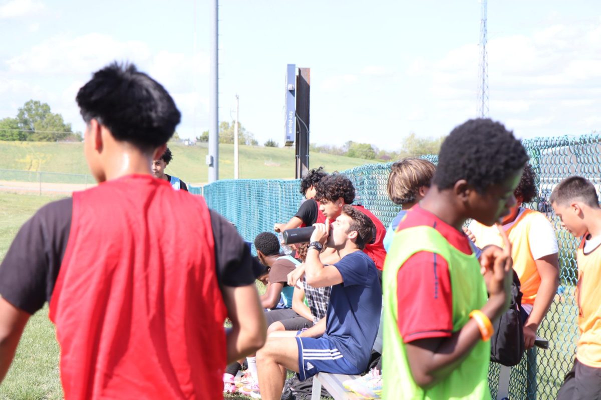 Players take a short break hydrating and talking while coaches prepare for the next drill. "The break helps us react so we can go harder in the next drill " Freshmen Michael Hernandez said.