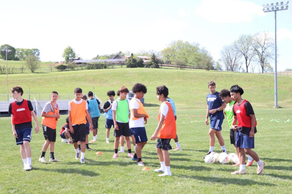 JV Boys soccer players warm up and begin misdirection drills, foucing on quick footwork and ball control. "We're working on fakes and movement to throw defenders off" 8th grader Adrian Albores said