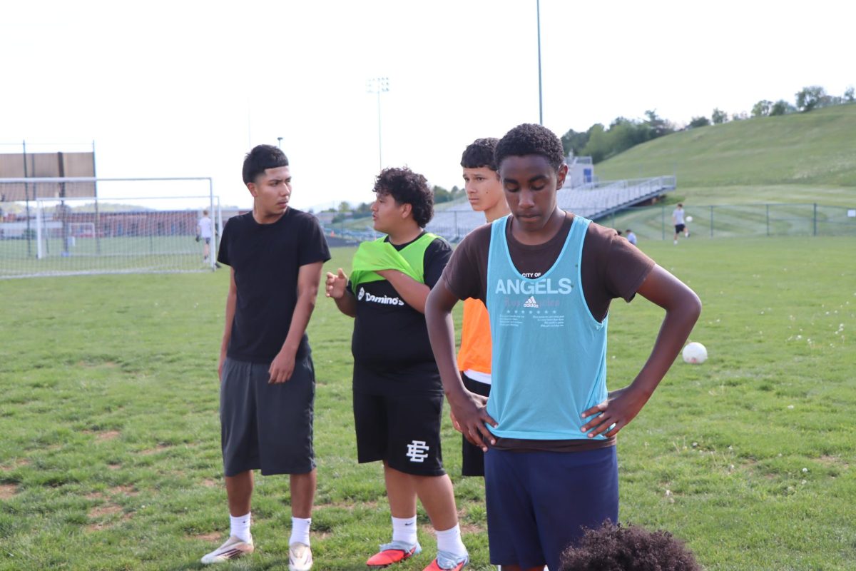 Teammates listen and prepare as the coach explains defensive positioning and strategy. "Communication is key when defending, we have to talk to each other" Freshman Alan Rios said.