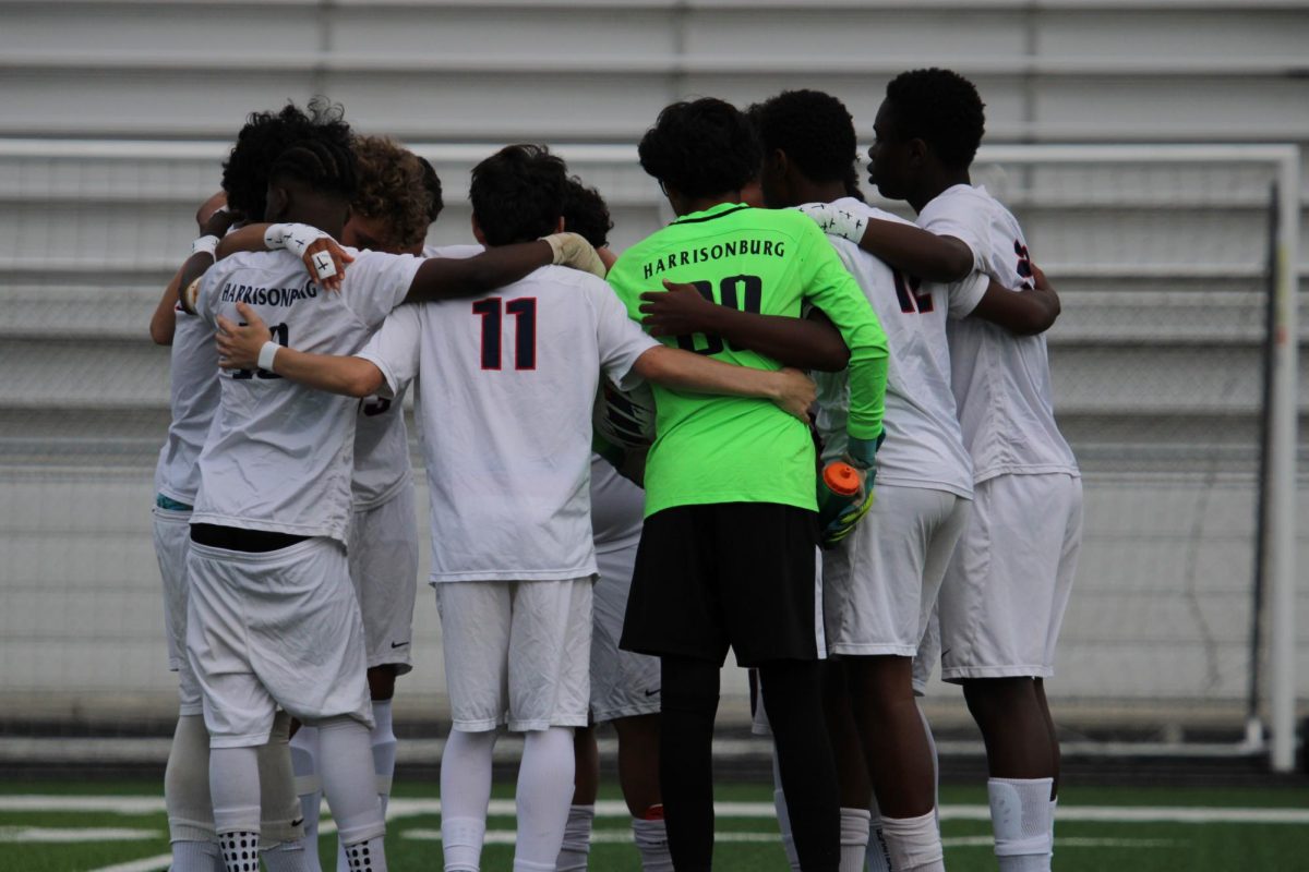 HHS Boys JV team huddling before kickoff.