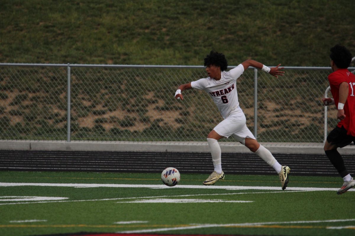 Freshman Michael Hernandez Castro sprinting down the line with the ball.