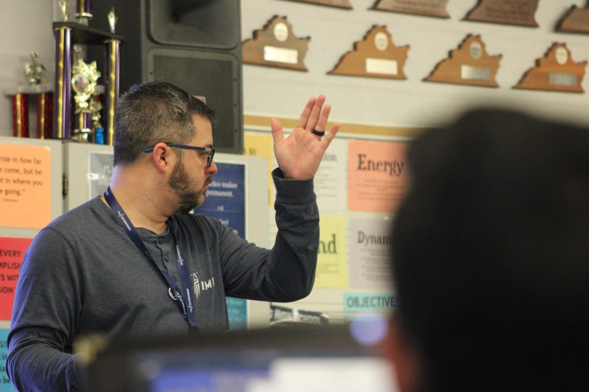 Mr. Upton conducts the band.